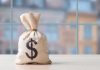 Money bag with dollar sign on table