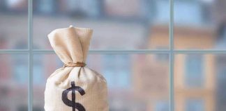 Money bag with dollar sign on table