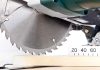 Close up of a circular saw blade cutting through a piece of wood
