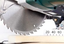 Close up of a circular saw blade cutting through a piece of wood