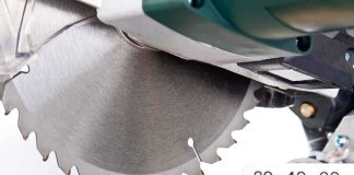 Close up of a circular saw blade cutting through a piece of wood
