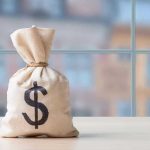 Money bag with dollar sign on table