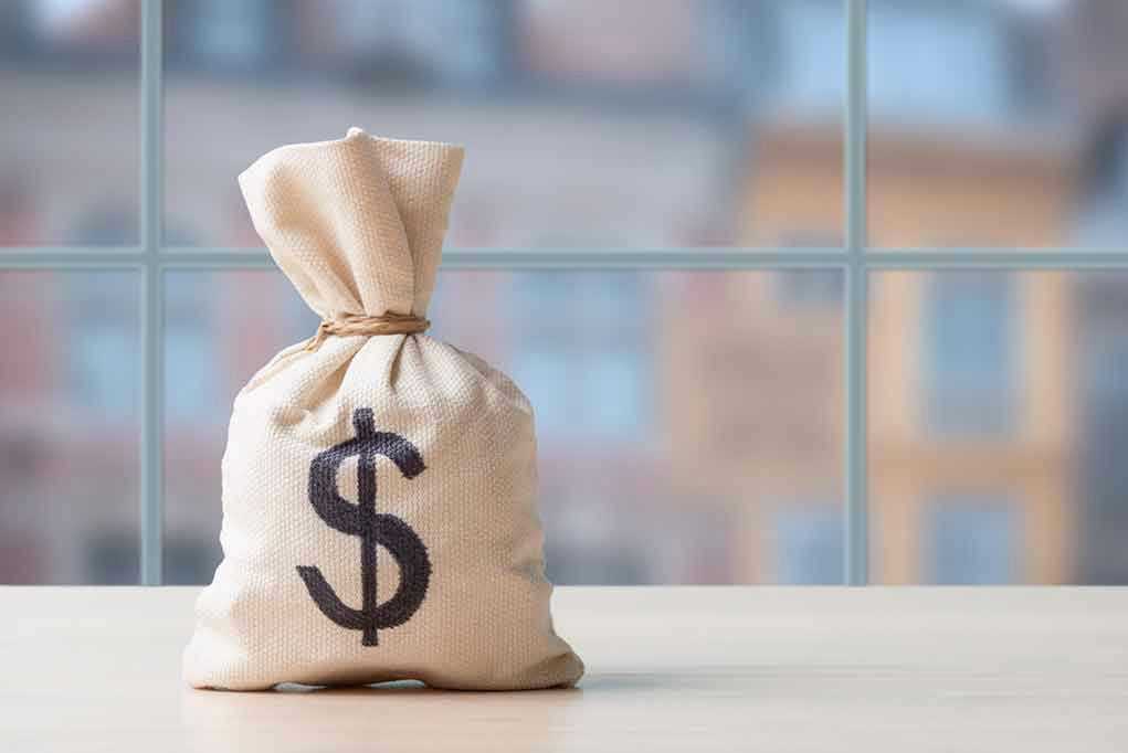 Wall Street Laughs as Savings Accounts Bleed Cash Money bag with dollar sign on table