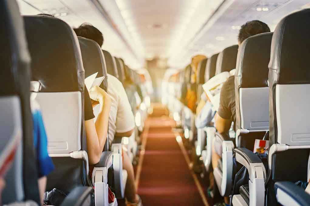 626651186 Passengers seated inside an airplane cabin