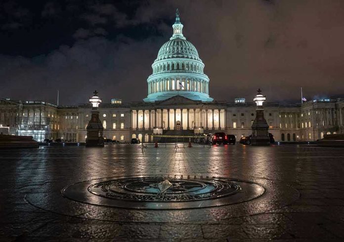 US Capitol building illuminated at night with wet pavement