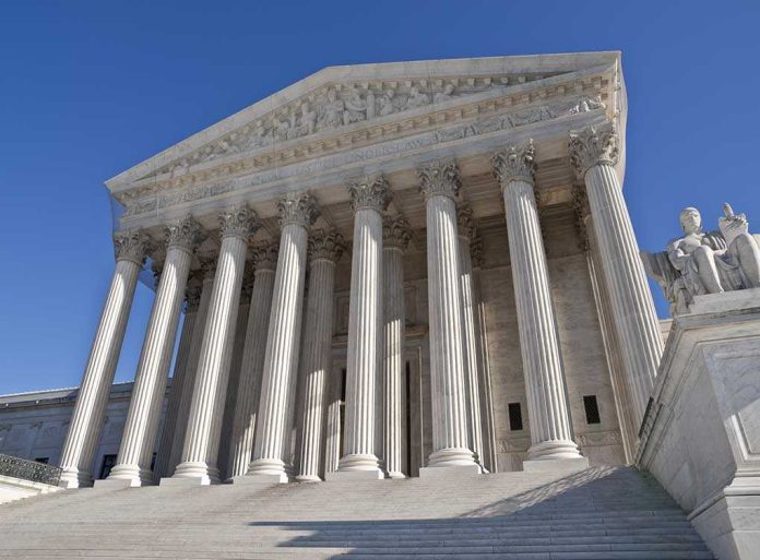 The Supreme Court building featuring grand columns and statues under a clear blue sky