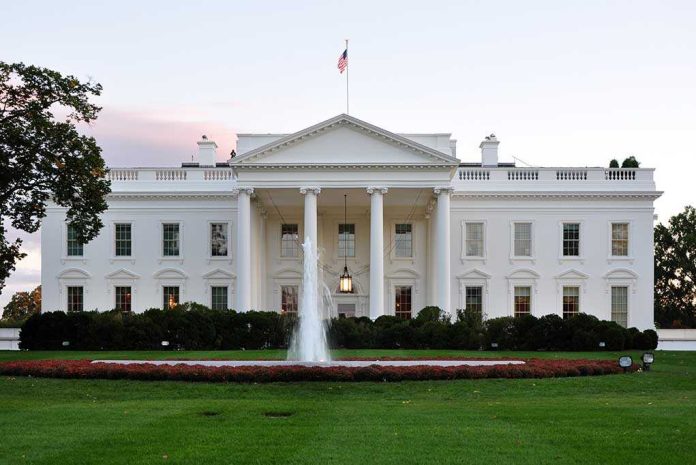 shutterstock_158620832.jpg The White House with a fountain in the foreground and an American flag flying