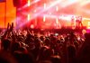 Crowd at concert with vibrant stage lights.