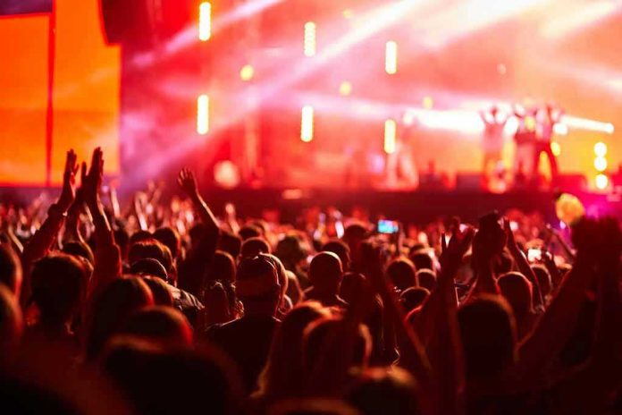 2454781497 Crowd at concert with vibrant stage lights.