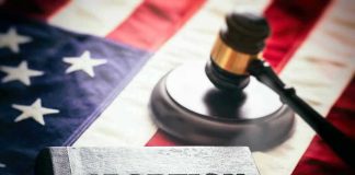 Abortion law book, gavel, and American flag.