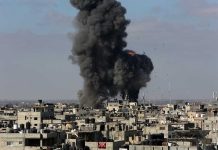 Large explosion over a crowded urban area.