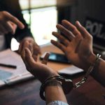 Person handcuffed in discussion with another person
