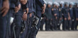 Line of police officers in uniform in formation.