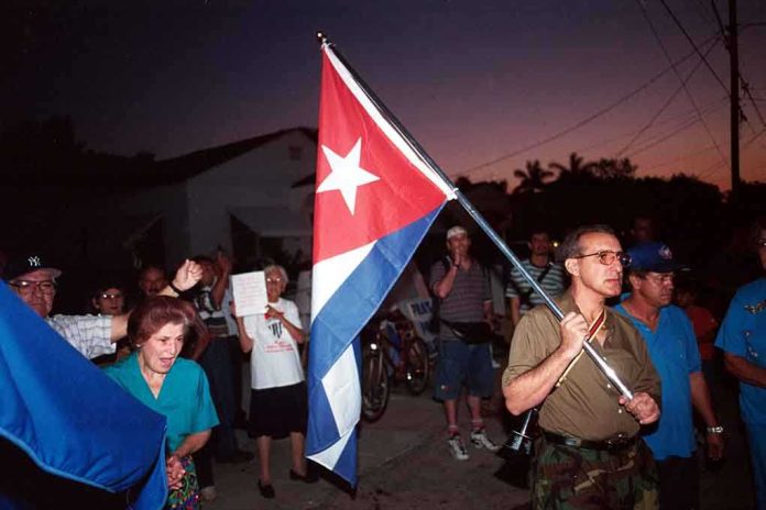 shutterstock_37307824 A group of people participating in a protest march holding a Cuban flag