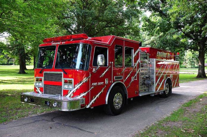shutterstock_45954856 A red fire truck parked in a green park