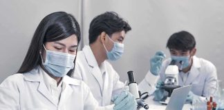 Researchers Report Drug Byproducts in City Water Scientists in lab coats working with test tubes and microscopes