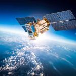 Satellite with solar panels orbiting above Earth