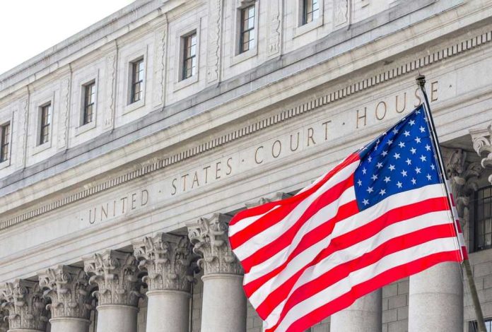 American flag waves before a neoclassical courthouse facade