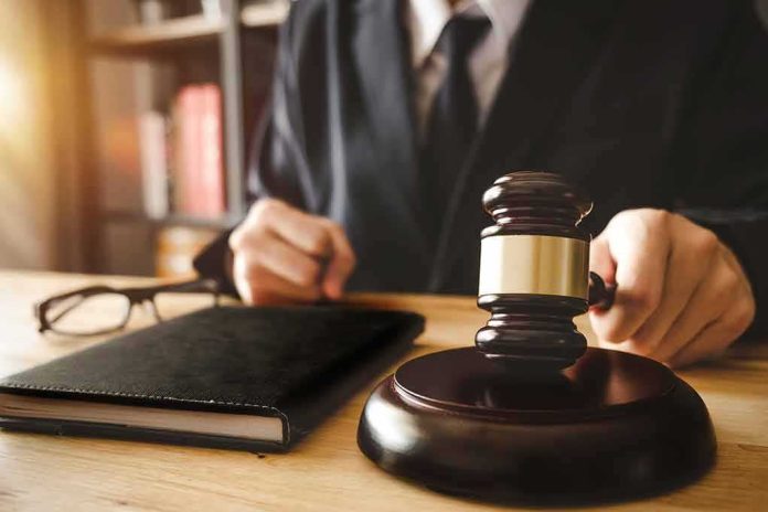 Judge with gavel striking sound block