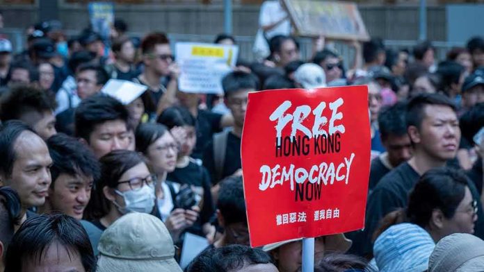 protest crowd holding a red sign