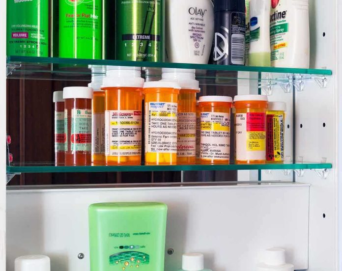 Medicine cabinet with prescription bottles and toiletries