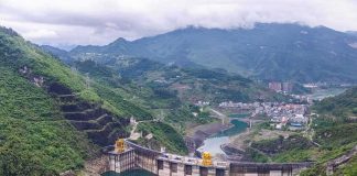 Hydroelectric dam in a green mountain valley