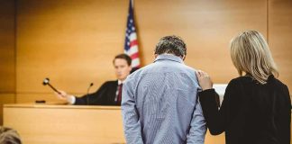 False Testimony Triggers Major Undo Defendant in handcuffs stands before a judge in a courtroom