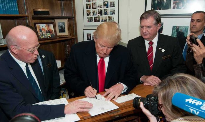 man in suit signing a document at a counter