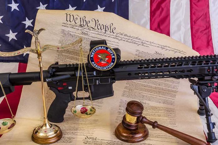 Rifle with NRA badge on Constitution backdrop with scales and gavel