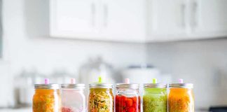 Assorted pickled vegetables in jars on a kitchen counter