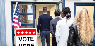Voters standing in line at a polling place entrance