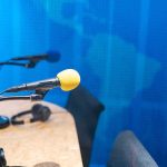 Podcast studio microphones on a desk