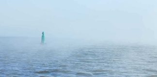 Major Hurricane Builds – Beach Danger Next Green buoy in foggy sea