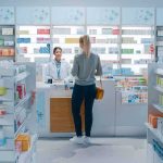 Yvonne Li assisting a customer at a pharmacy counter