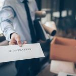 employee handing over a resignation letter