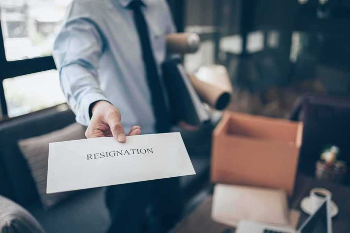 shutterstock_2022335198 employee handing over a resignation letter