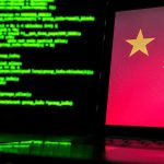 Laptop screen with Chinese flag beside green computer code
