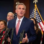 Kevin McCarthy speaks at a podium with Elise Stefanik, Tom Emmer, and Richard Hudson behind him