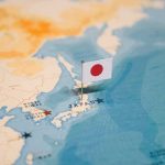Japanese flag pin marking Japan on a world map