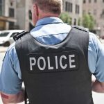 Police officer in uniform from behind on a city street