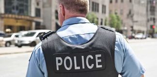 Police officer in uniform from behind on a city street