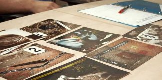 Crime scene photos laid out on a desk