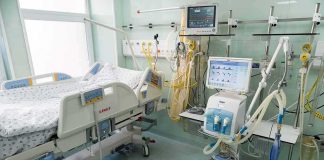 Hospital ICU bed with ventilator and monitoring equipment