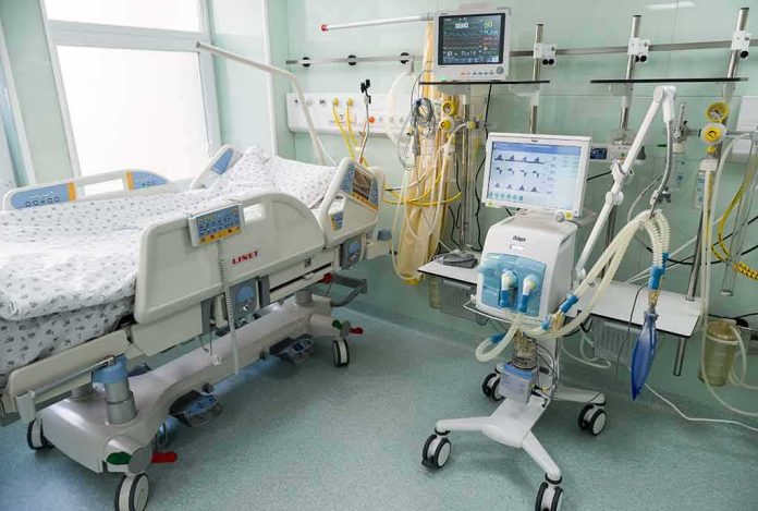 Hospital ICU bed with ventilator and monitoring equipment