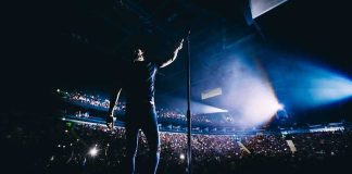Vegas Shock: Headliner Down, Stage Goes Dark Singer on stage facing a large concert crowd
