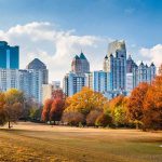 City skyline behind a park with autumn trees