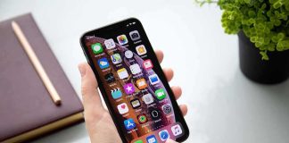 Person using a smartphone with apps on the home screen