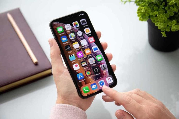 Person using a smartphone with apps on the home screen