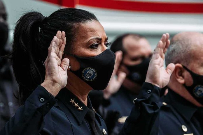 Police officers wearing masks raise right hands during oath ceremony