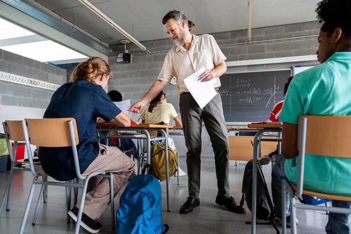 Teacher handing out papers in a classroom